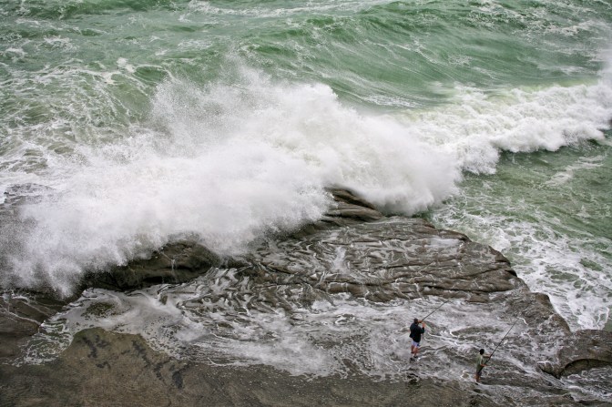 Hazardous fishing at Muriwai Regional Park near Auckland