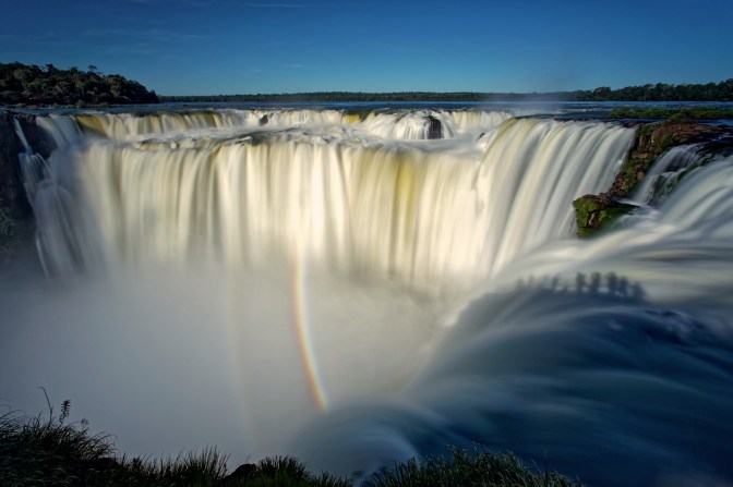 Selfie seekers silhouetted on the Devils Throat, Argentina
