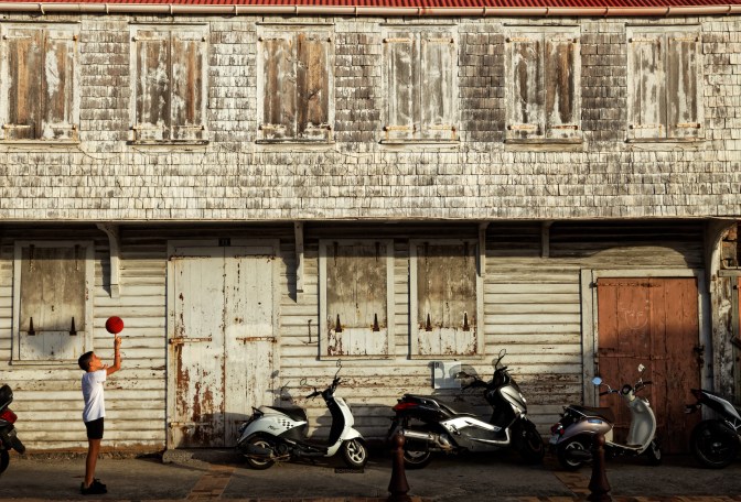 Ball balancing boy, Gustavia, Saint Barthélemy